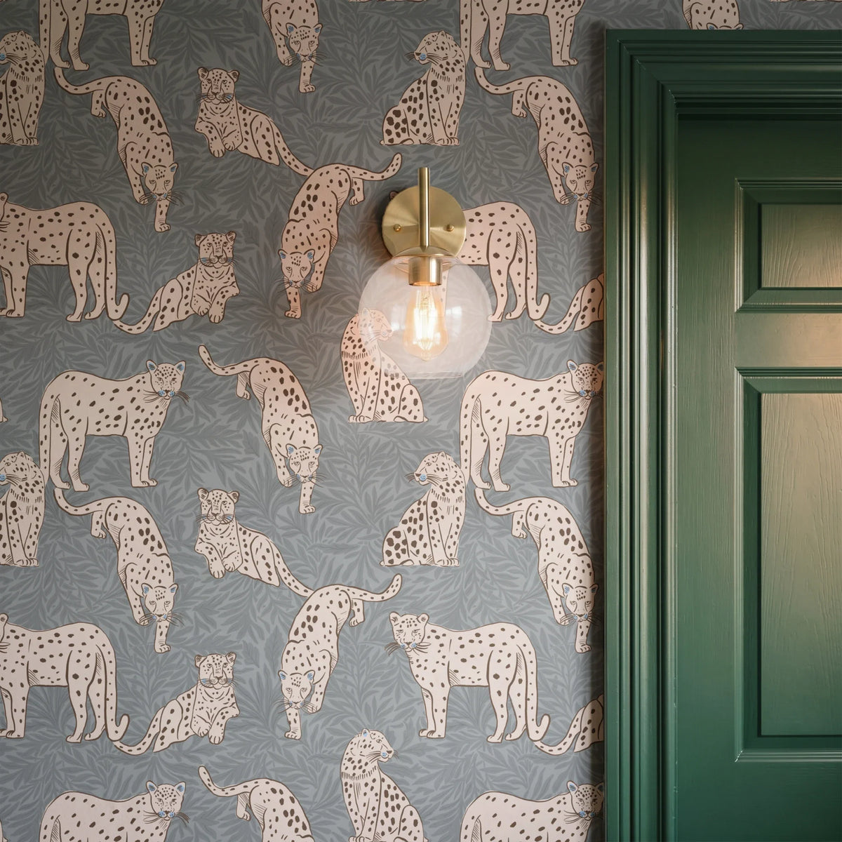 Leopards in various poses on gray background with leaf pattern