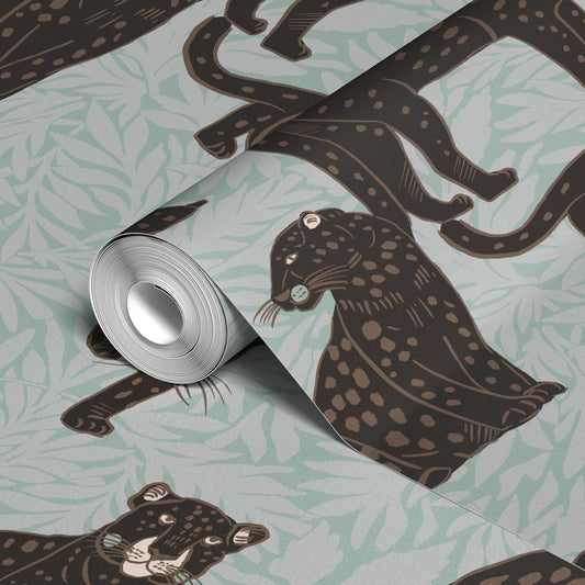 Black leopards with spotted coats on light blue background with leaf pattern